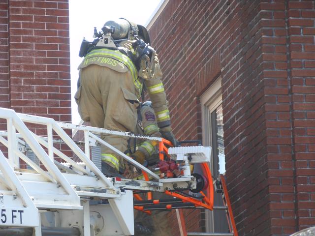 Firefighter Alan Hastings prepares to access the roof.